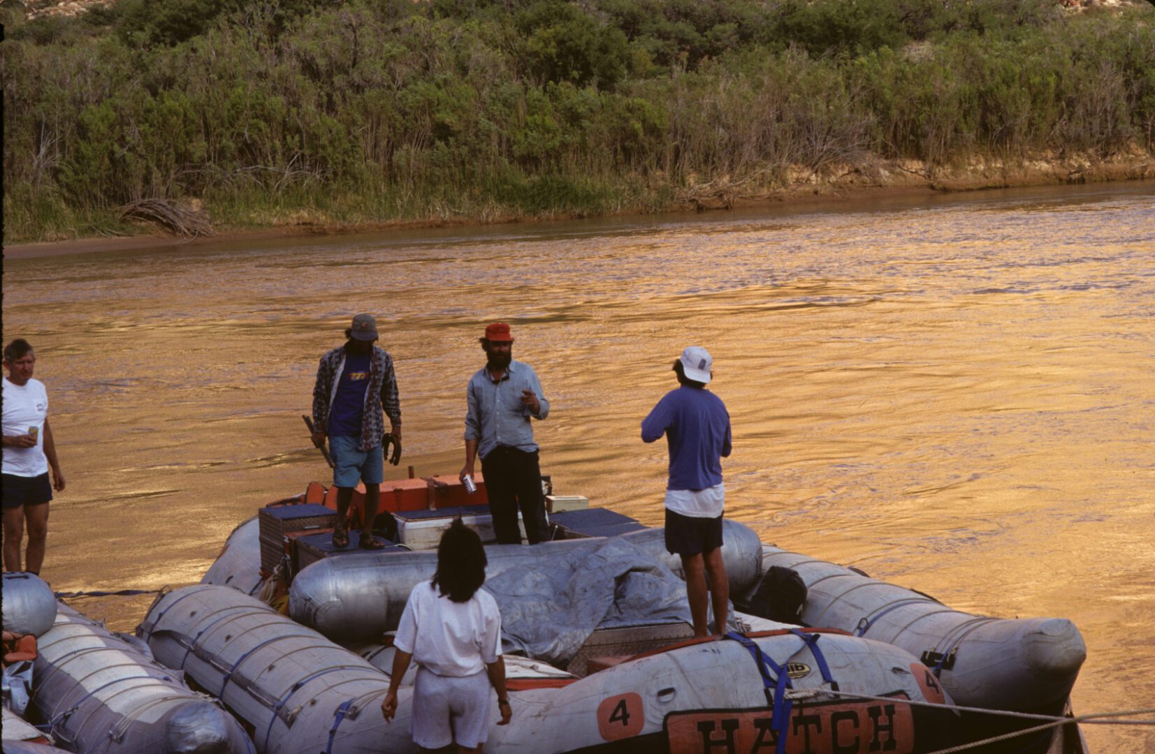 A group of people on a raft in the water.