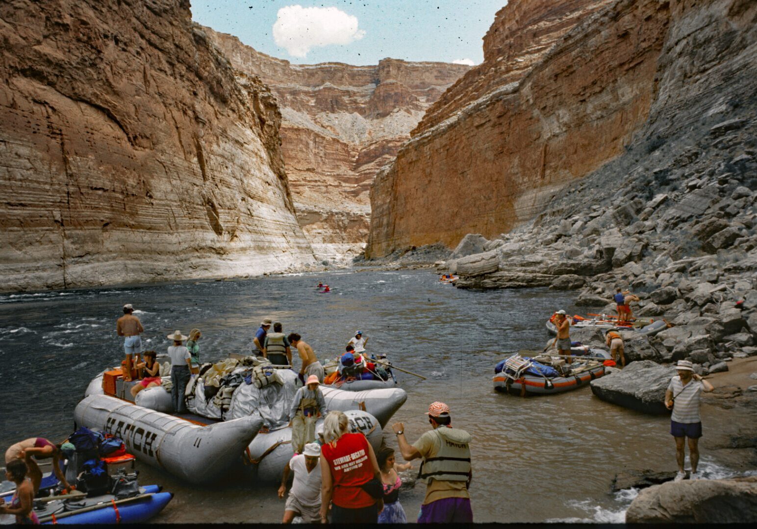 A group of people in rafts on the water.