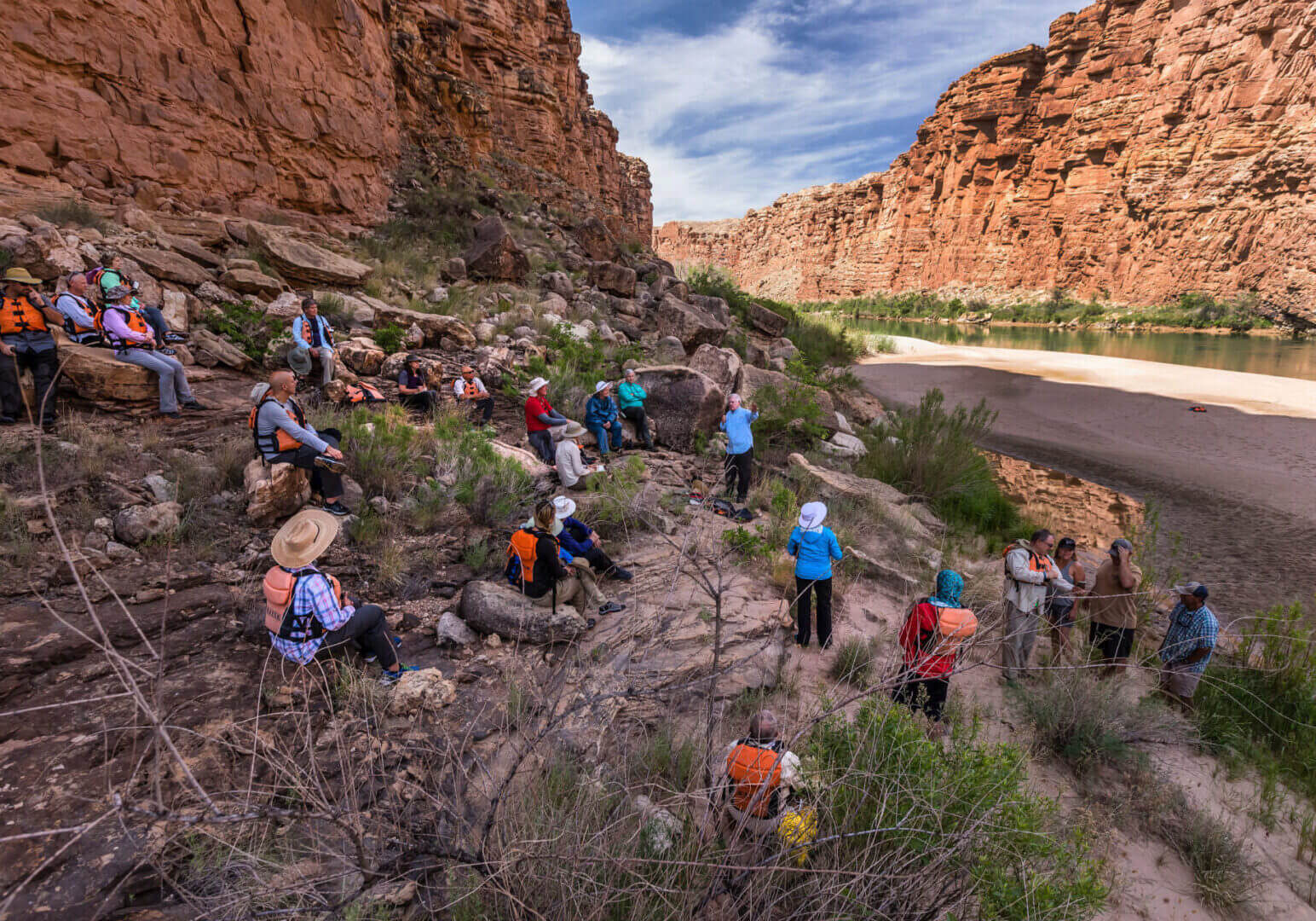 A group of people hiking up the side of a mountain.